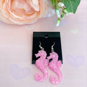 Pink seahorse earrings plastic.